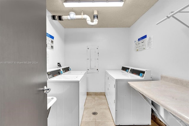 2801 NE 183rd St Unit 1603W, Aventura, FL 33160 - shared laundry area featuring light tile patterned floors, a textured ceiling, independent washer and dryer, and baseboards