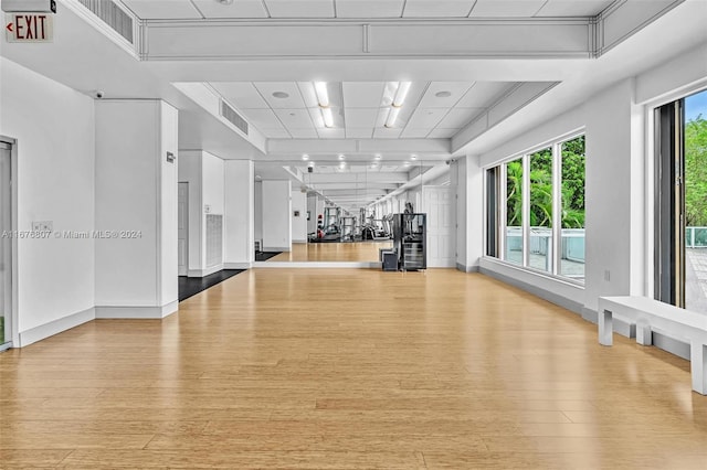 2801 NE 183rd St Unit 1603W, Aventura, FL 33160 - exercise area with visible vents, baseboards, a raised ceiling, and light wood-type flooring
