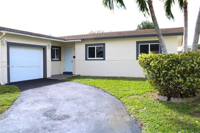 ranch-style home with a front yard and a garage