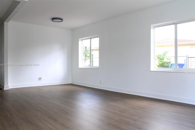 empty room with dark wood-type flooring