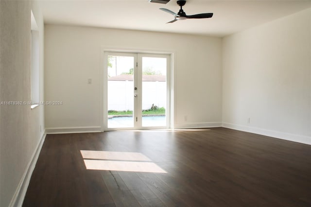 spare room with french doors, dark hardwood / wood-style floors, and ceiling fan