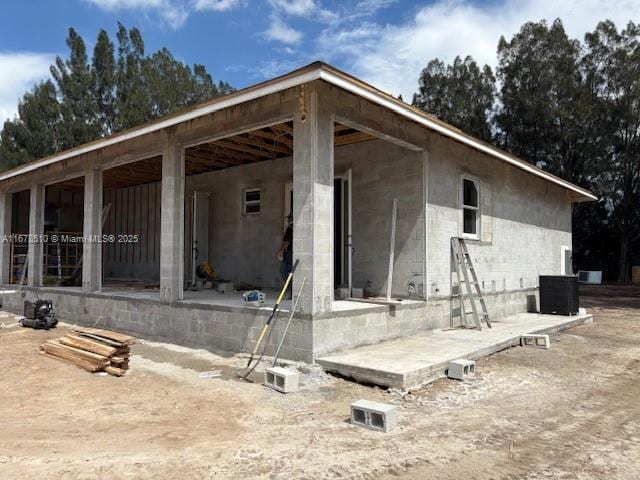 back of house featuring central AC unit