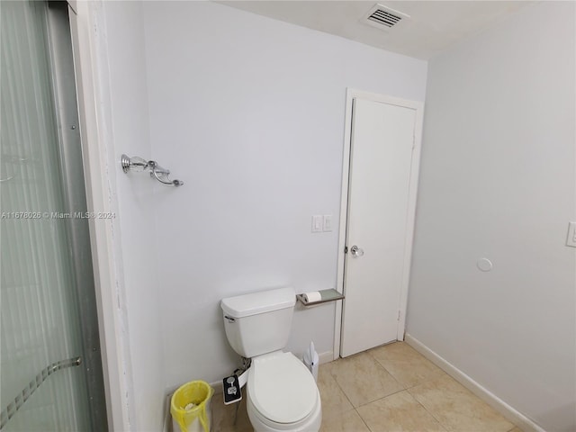 bathroom with toilet and tile patterned flooring