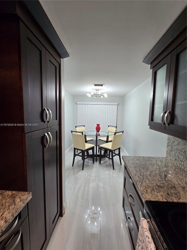 kitchen with dark brown cabinetry and light stone counters