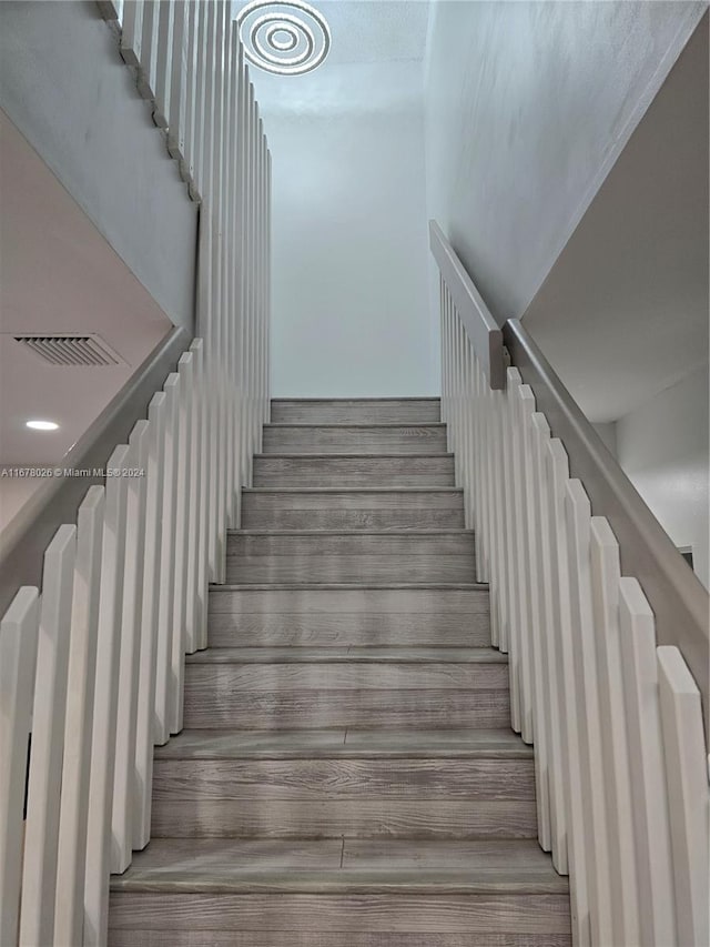 stairway featuring hardwood / wood-style floors