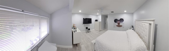 bedroom with vaulted ceiling and light wood-type flooring