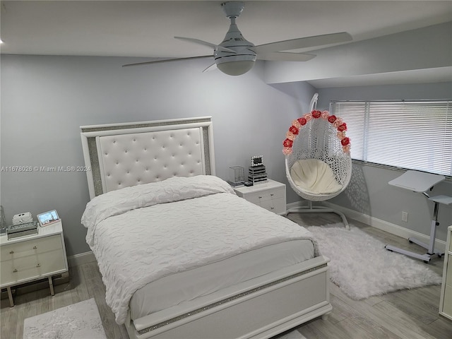 bedroom featuring lofted ceiling, hardwood / wood-style flooring, and ceiling fan