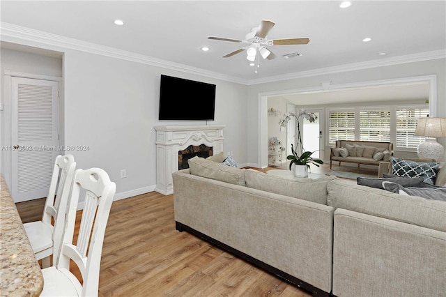 living room with crown molding, hardwood / wood-style flooring, and ceiling fan