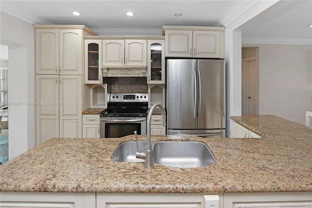 kitchen with cream cabinetry, crown molding, sink, light stone countertops, and appliances with stainless steel finishes