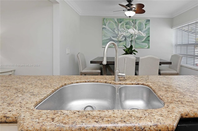 kitchen featuring crown molding, sink, and ceiling fan