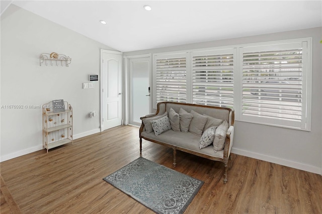 sitting room featuring vaulted ceiling, a healthy amount of sunlight, and dark hardwood / wood-style flooring