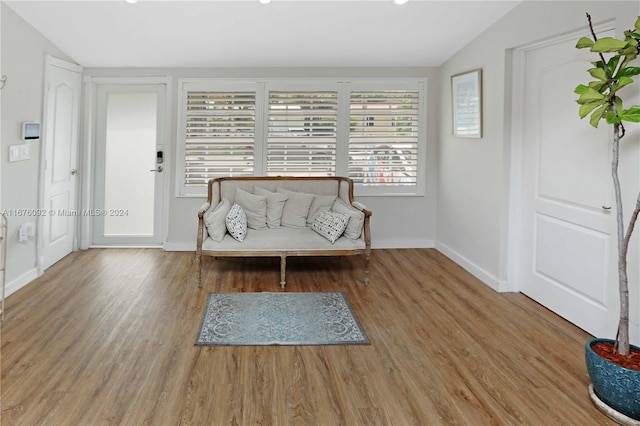 unfurnished room featuring wood-type flooring and lofted ceiling