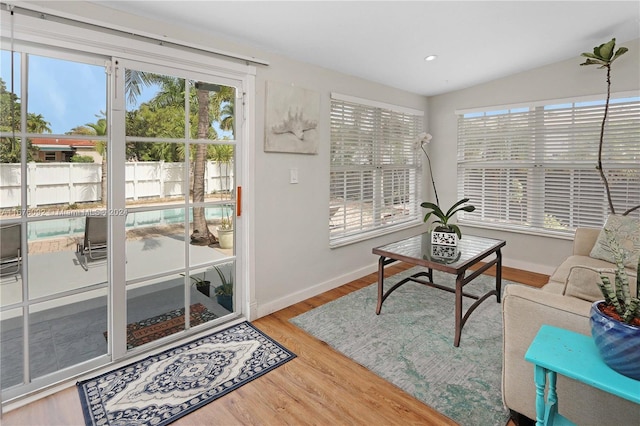 interior space featuring light hardwood / wood-style floors and vaulted ceiling