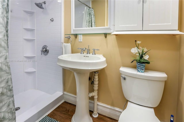 bathroom with toilet, sink, a shower with curtain, and hardwood / wood-style floors