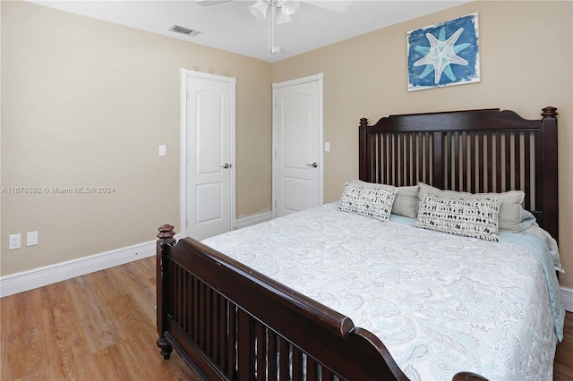 bedroom with hardwood / wood-style floors and ceiling fan