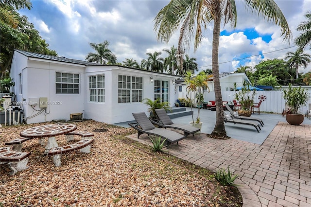 back of house featuring an outdoor fire pit and a patio area