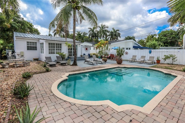 view of swimming pool featuring a patio and an outdoor structure