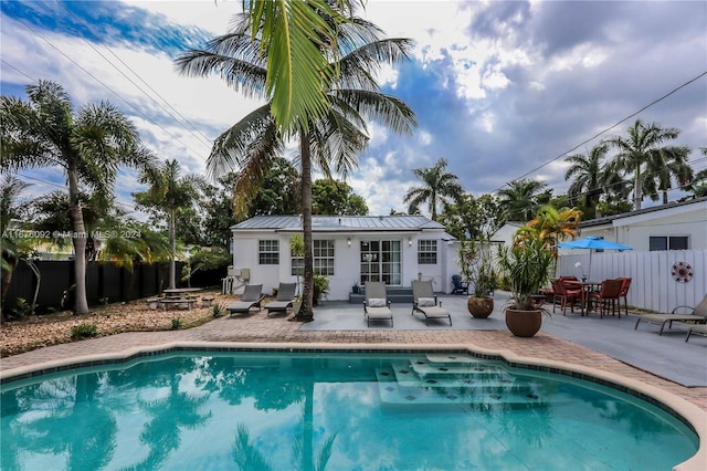 back of house with a patio and a fenced in pool