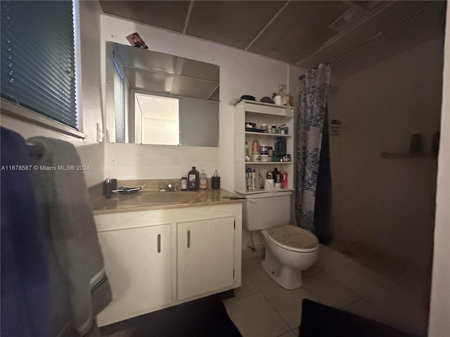 bathroom featuring vanity, curtained shower, toilet, and tile patterned flooring