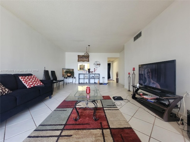 tiled living room featuring a textured ceiling