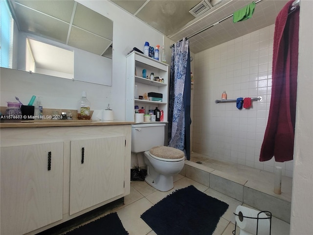 bathroom with vanity, a shower with shower curtain, toilet, and tile patterned floors