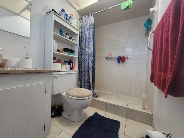 bathroom with toilet, curtained shower, vanity, and tile patterned floors