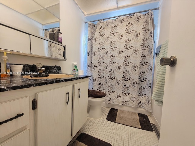 full bathroom with vanity, shower / bath combo with shower curtain, toilet, and tile patterned floors