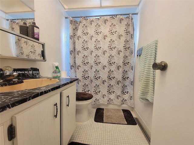 bathroom with vanity, a shower with curtain, toilet, and tile patterned floors