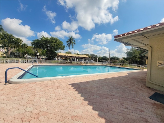 view of swimming pool with a patio area