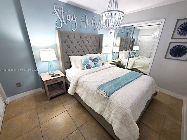 bedroom with tile patterned flooring and a chandelier