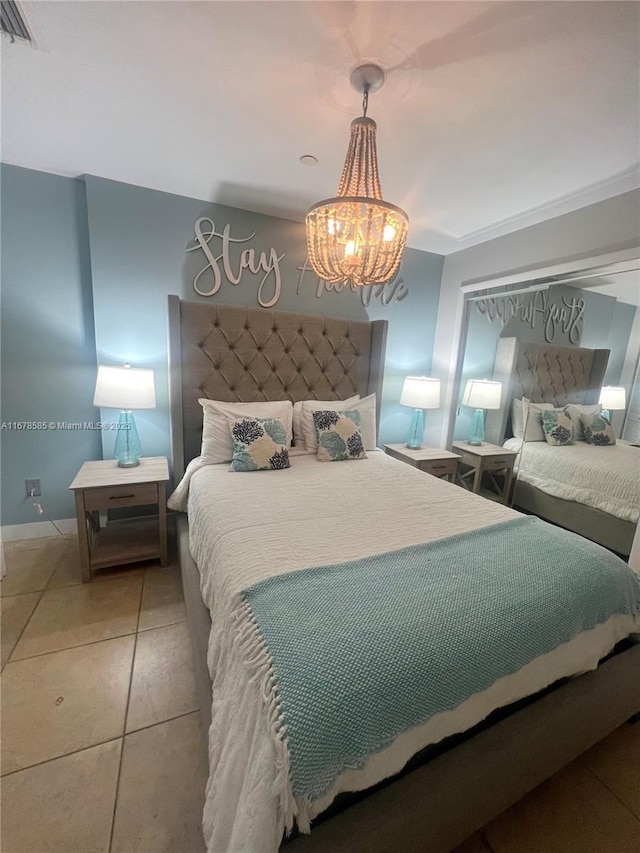 bedroom featuring light tile patterned flooring and a notable chandelier