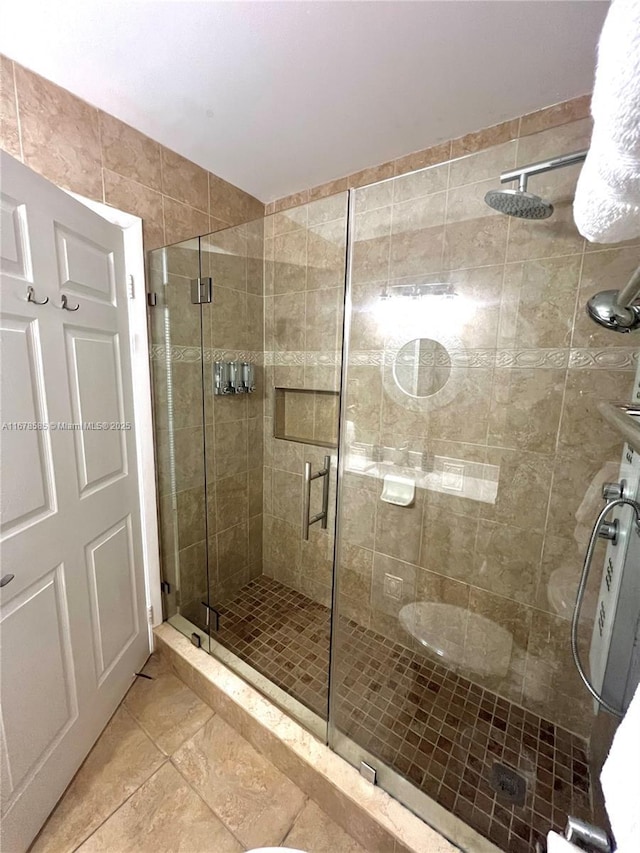 bathroom featuring tile patterned floors and a shower with door