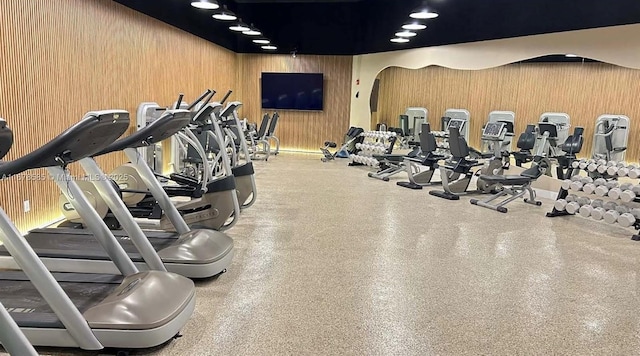 workout area featuring wood walls