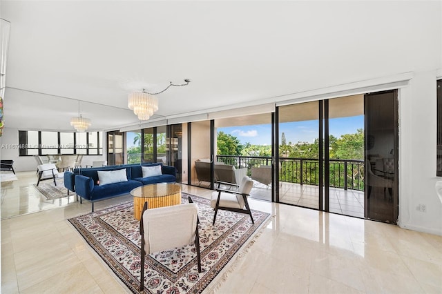 living room with a chandelier and a wall of windows