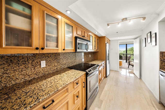 kitchen featuring decorative backsplash, track lighting, stainless steel appliances, light tile patterned floors, and light stone counters