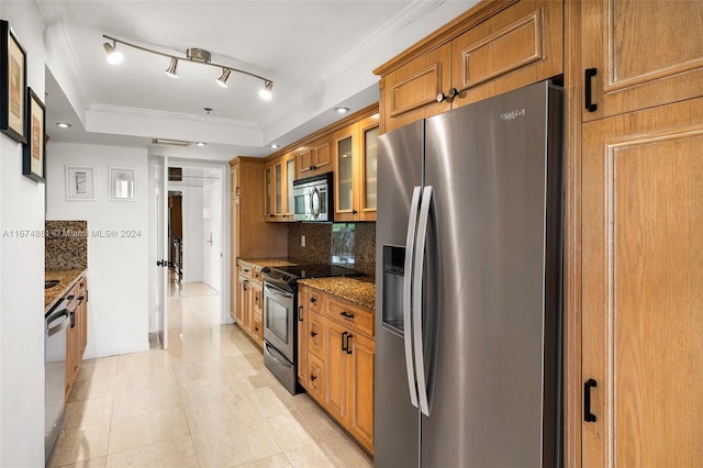 kitchen featuring tasteful backsplash, a raised ceiling, appliances with stainless steel finishes, dark stone counters, and crown molding