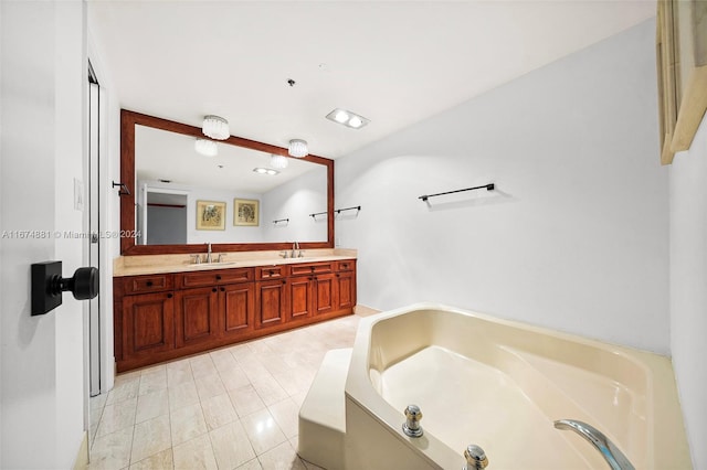 bathroom featuring vanity, a tub, and tile patterned flooring