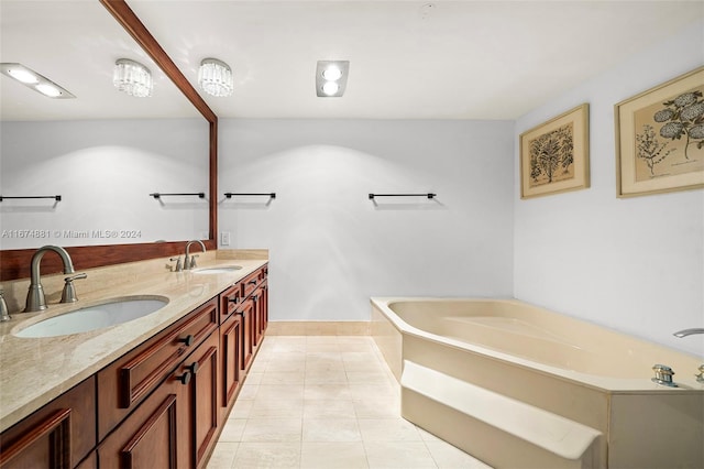 bathroom with vanity, a tub, and tile patterned floors