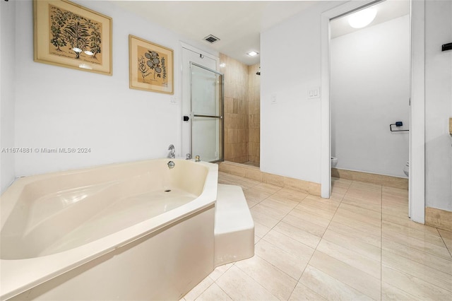 bathroom featuring tile patterned floors, plus walk in shower, and toilet