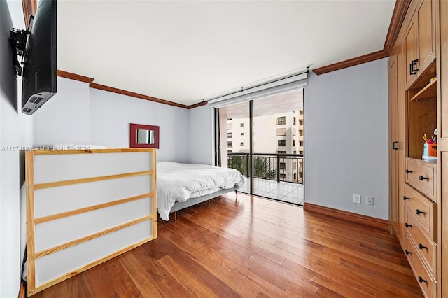 unfurnished bedroom with wood-type flooring, ornamental molding, floor to ceiling windows, and access to exterior