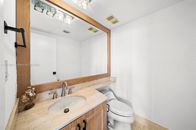 bathroom featuring vanity, toilet, and tile patterned floors