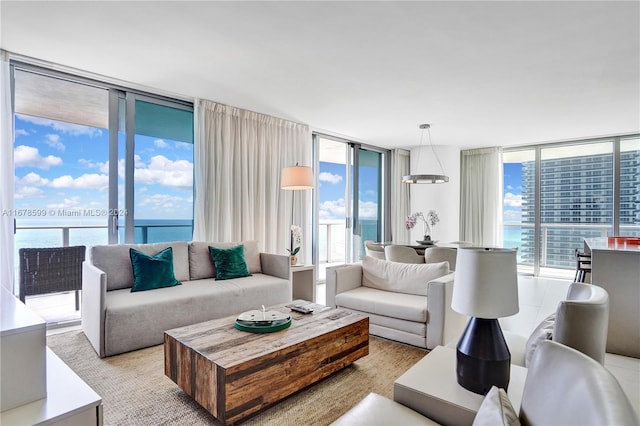 living room featuring a water view and a wall of windows