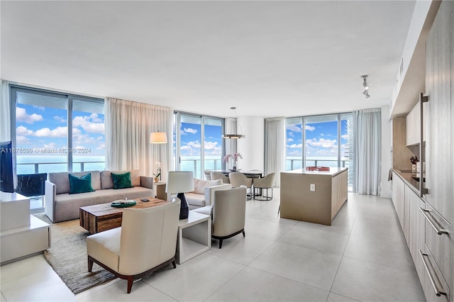 living room featuring a water view and a wall of windows