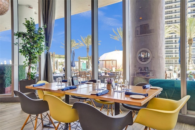 dining area featuring light hardwood / wood-style floors and expansive windows