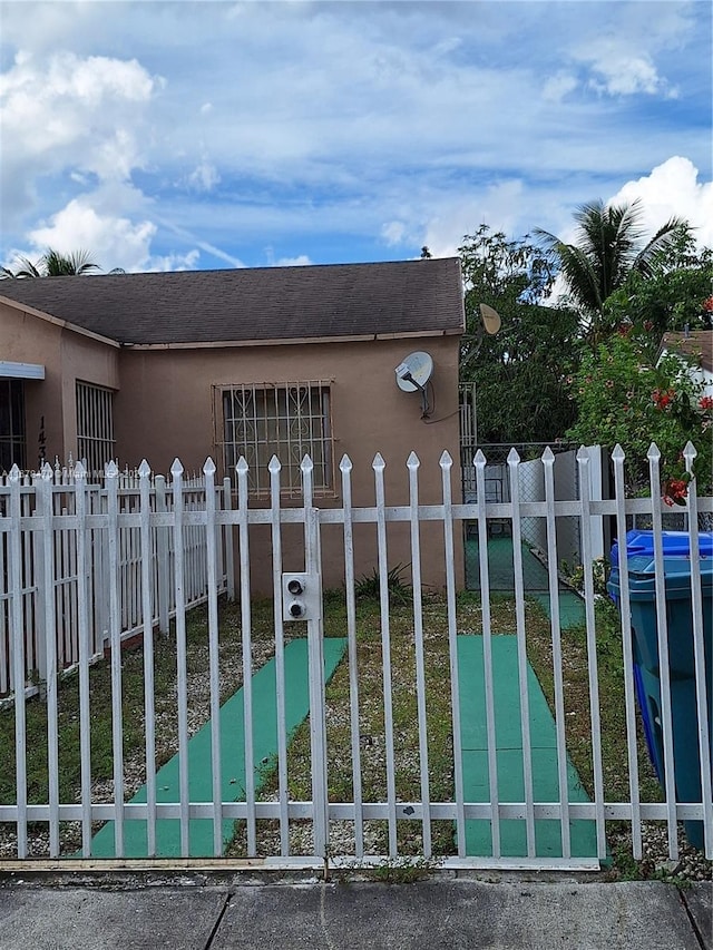 view of gate with a yard