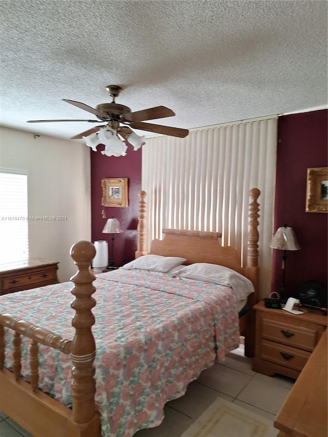 tiled bedroom featuring a textured ceiling and ceiling fan