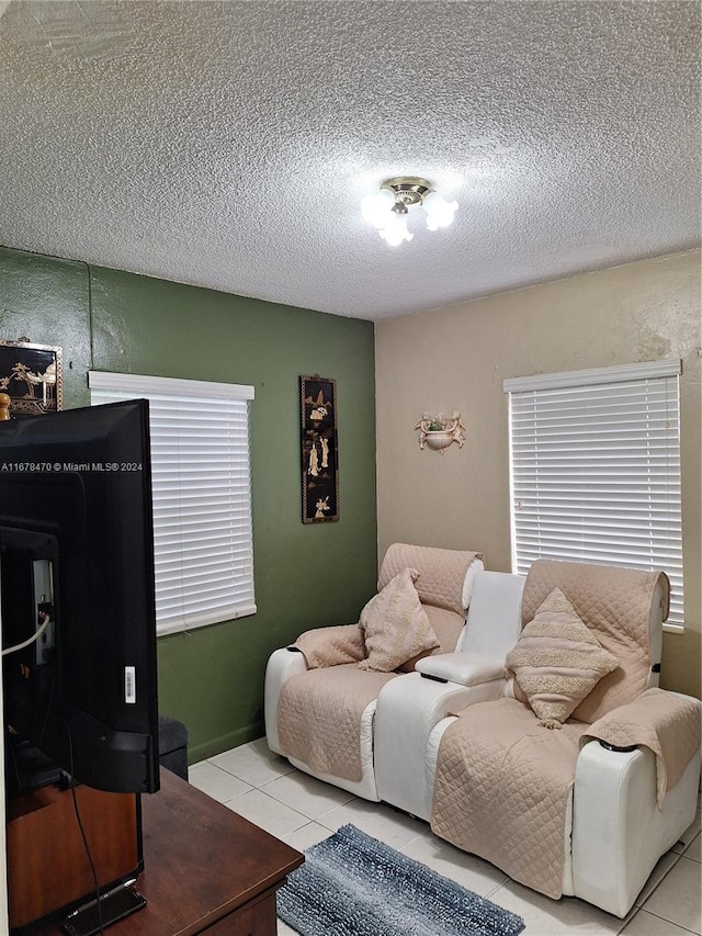 bedroom with a textured ceiling and light tile patterned floors