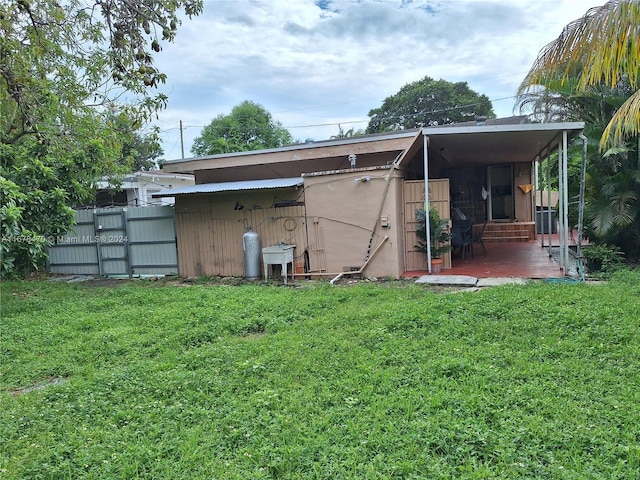 rear view of property with a lawn