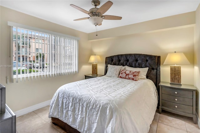 tiled bedroom featuring multiple windows and ceiling fan