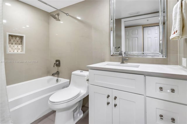 full bathroom with toilet, tile patterned flooring, vanity, shower / tub combo with curtain, and tile walls